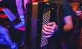 The musician plays the accordion close-up club. Royalty Free Stock Photo