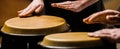 The musician plays the bongo. Close up of musician hand playing bongos drums. Afro Cuba, rum, drummer, fingers, hand