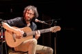 Musician plays Brazilian 7-string guitar on a stage