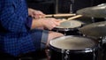 Musician plays drams with drumsticks in slow motion
