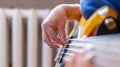 The musician plays a five-string bass guitar at home