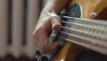 The musician plays a five-string bass guitar at home