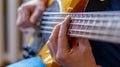 The musician plays a five-string bass guitar at home