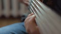 The musician plays a five-string bass guitar at home