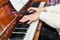 The musician plays the piano by controlling the keys and looking at the notes Royalty Free Stock Photo