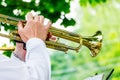 The musician plays the trumpet during an outdoor concert_ Royalty Free Stock Photo