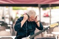 Musician preparing the microphone to perfom in te stage of a terrace