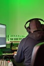 Musician, producer in headphones, working in the studio on creating and recording music. Back view of man wearing headphone Royalty Free Stock Photo