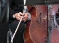 Musician`s hands hold bow. Fragment of cello close up.
