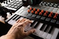 Musician`s hand on a modern synthesizer, midi keyboard. Recording studio. Musician, composer, sound engineer. Sound work, podcast Royalty Free Stock Photo