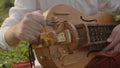 Musician's hands play the hurdy-gurdy