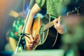 Musician`s hands playing guitar at a live show on stage Royalty Free Stock Photo