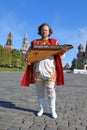 Musician with music instrument gusli standing on red Square