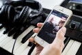 Musician using his iPhone to listen to music on Apple Music.