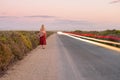 Musician walking down a secluded road Royalty Free Stock Photo