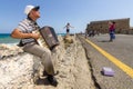 Musician on the waterfront plays accordion