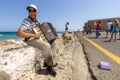 Musician on the waterfront plays accordion