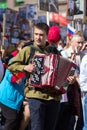 Musician wearing military uniform with accordion on parade of Victory Day.