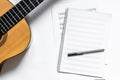 Musician work set with blank paper for notes and guitar white table background top view space for text Royalty Free Stock Photo