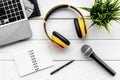 Musician work space with microphone, notebook, laptop and headphones on white wooden background top view space for text Royalty Free Stock Photo