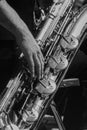 Baritone saxophone player. Hands and instrument details