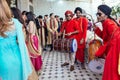 Musicians band wearing red Bandhgala and black Pheta at Indian wedding ceremony in Bangkok, Thailand