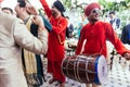 Musicians band wearing red Bandhgala and Pheta at Indian wedding ceremony in Bangkok, Thailand