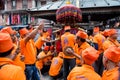 Musicians dressed in orange playing during celebration ceremony