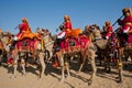 Musicians going to the colorful camel Desert Festival Royalty Free Stock Photo