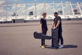 musicians with musical instruments in cases having conversation while standing