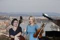 Musicians play the violin and contrabass Image on the background of the city