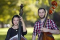 Musicians play the violin and contrabass Image on the background of the city