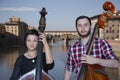 Musicians play the violin and contrabass Image on the background of the city