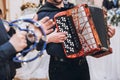 Musicians playing on accordion and tambourine, musical band performing at wedding reception. fun time at party