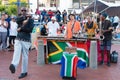 Musicians making music, singing, dancing and showing flag of South Africa at the Waterfront in Cape Town. Royalty Free Stock Photo