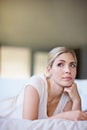 Musings with myself. a beautiful young woman lying in bed and looking thoughtful.