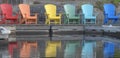 Colorful chairs in a row on the dock at the lake in summer Royalty Free Stock Photo