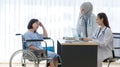 Muslim Arab Islam wears hijab and Asian female doctor in white lab coat uniform with stethoscope consulting asking discussing with