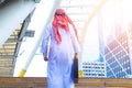 Muslim Arab man. He standing hold bag and document.