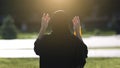 Morning prayer of an eastern woman on the street.