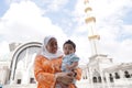 Muslim asian lady and her adorable son at a mosque Royalty Free Stock Photo