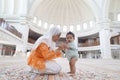 Muslim asian lady and her adorable son at a mosque Royalty Free Stock Photo