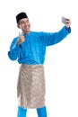 muslim asian male taking picture of his self Royalty Free Stock Photo