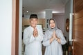 muslim asian senior couple standing at front door waiting for family Royalty Free Stock Photo