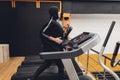 Muslim asian woman in hijab exercizing in a gym.