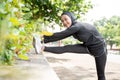 muslim asian woman strecth her leg during sport time outdoor Royalty Free Stock Photo