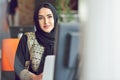 Muslim asian woman working in office with laptop