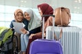 Muslim asian woman friend sitting in airport terminal Royalty Free Stock Photo