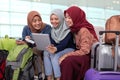 Muslim asian woman friend sitting in airport terminal Royalty Free Stock Photo