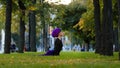 Muslim athletic woman practice yoga sun salutation in park on grass morning routine up facing dog pose asana for body Royalty Free Stock Photo